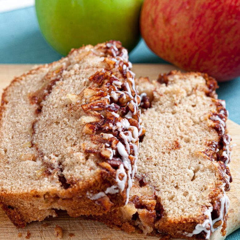 2 slices of apple streusel loaf bread on a cutting board