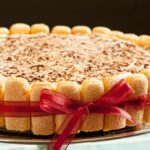 a tiramisu recipe with ladyfingers wrapped in red ribbon