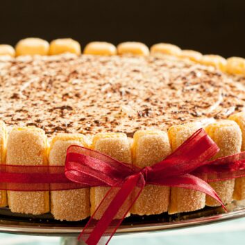 a tiramisu recipe with ladyfingers wrapped in red ribbon