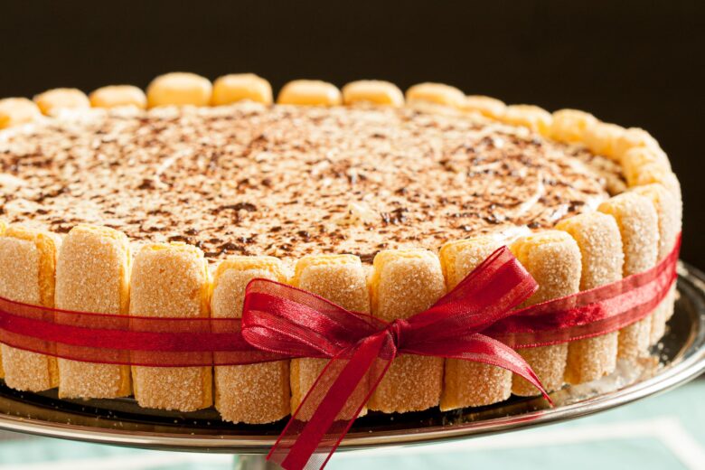 a tiramisu recipe with ladyfingers wrapped in red ribbon