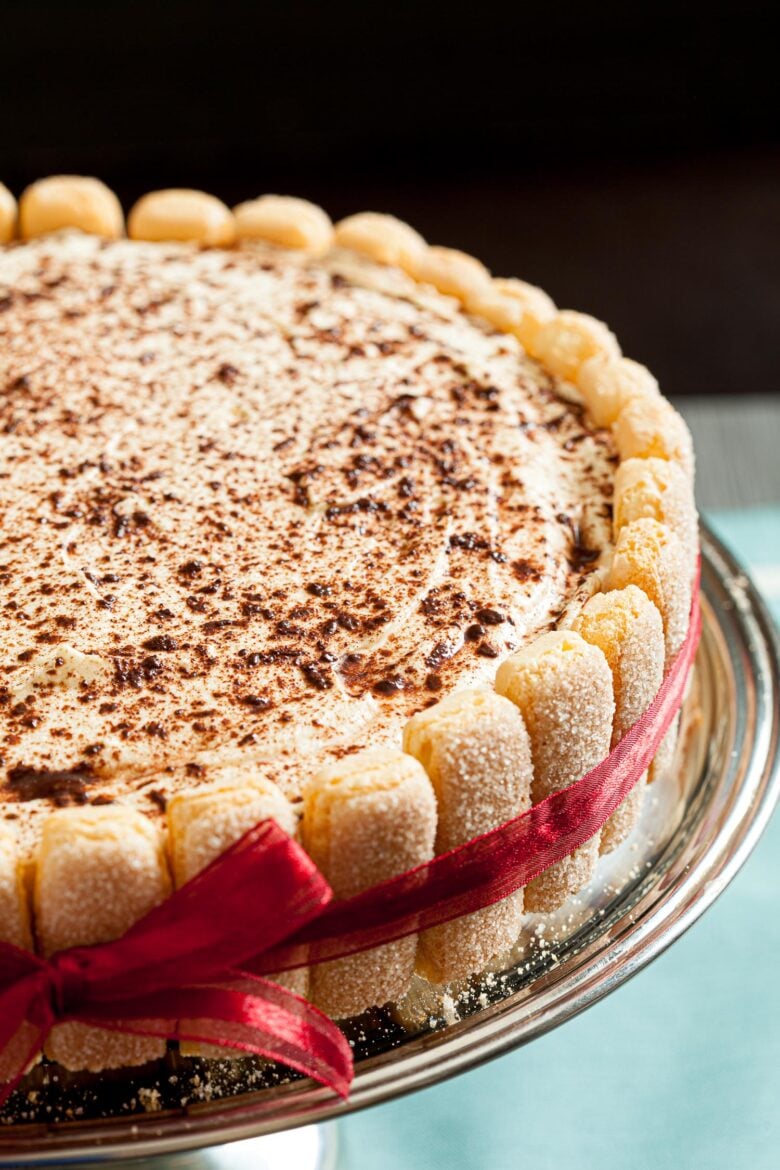 A tiramisu cake dusted with chocolate shavings on top.