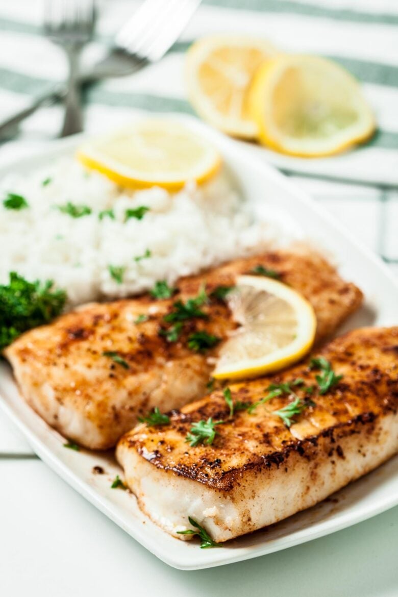 lemon butter fish fillets on white plate