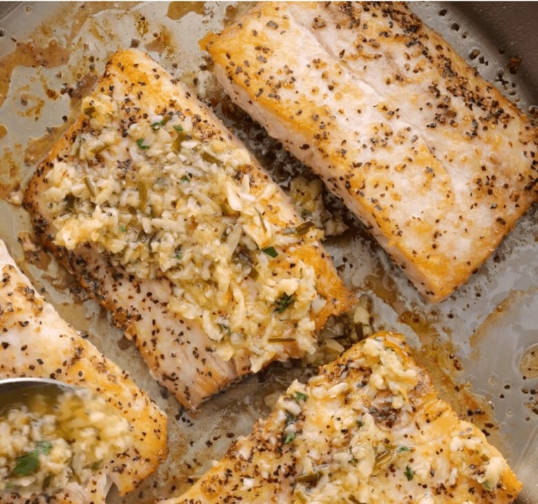 Mahi Mahi cooking in the hot pan in the oven.
