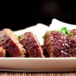 sliced teriyaki meatloaf on a white platter