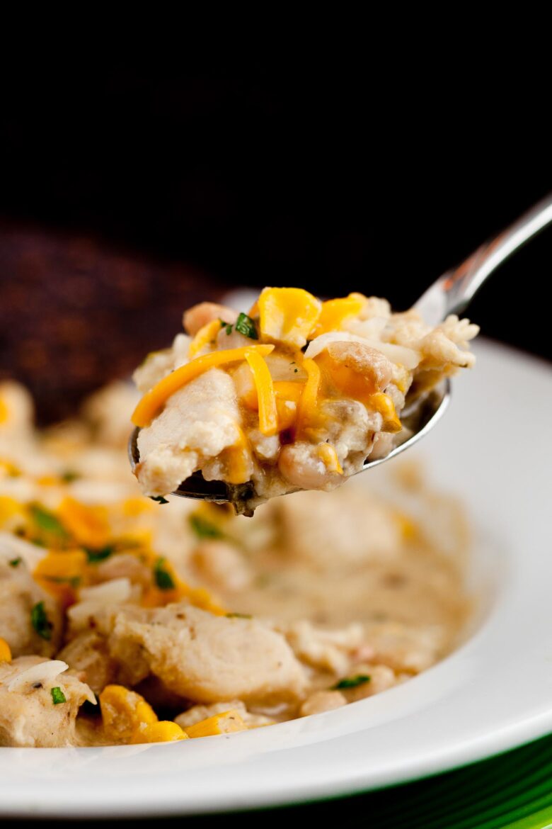 white chicken chili on a plate with spoon