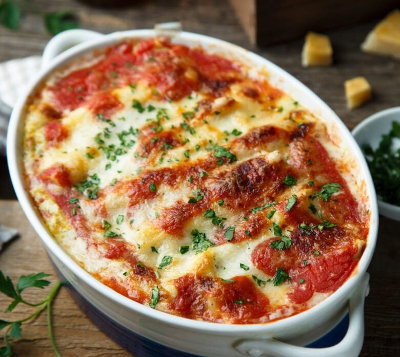 Baked Ravioli Casserole in a dish with melted cheese on top. 