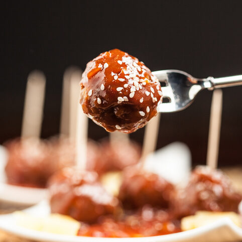 sweet and sour meatballs on fork