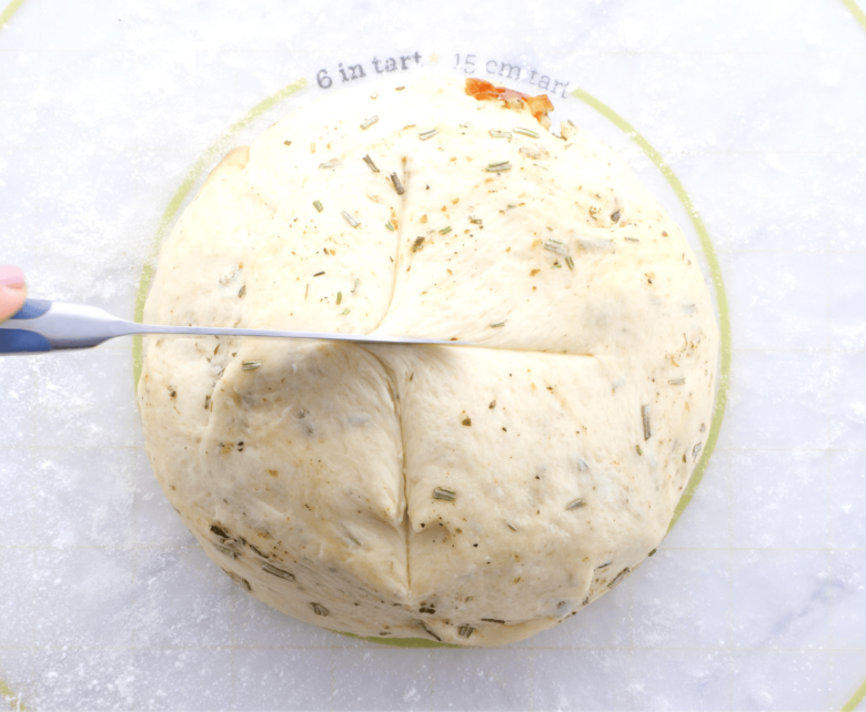 Rosemary bread cutting criss cross for second rise.