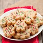shortbread cookies with sprinkles on a white plate.