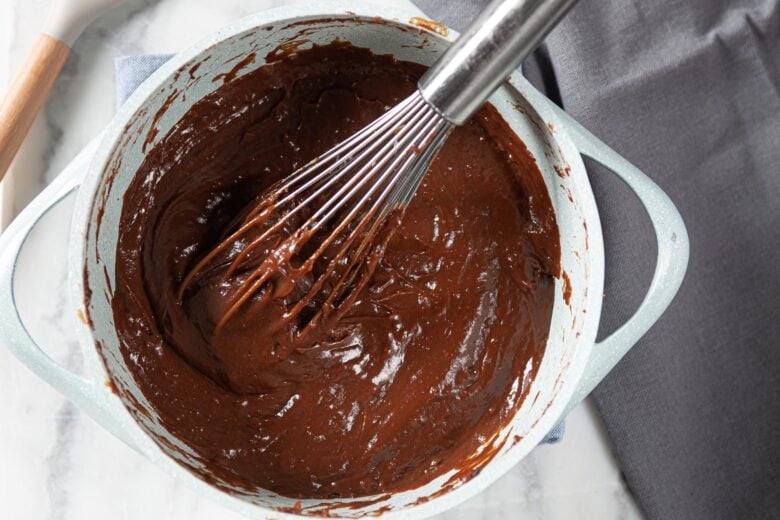 chocolate pie filling ingredients in a pot being stirred
