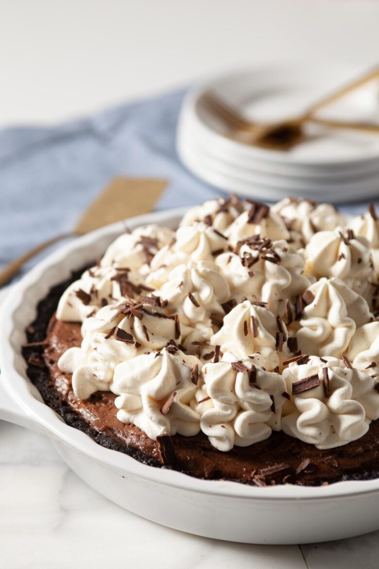 Chocolate pie with whipped cream in a pie plate
