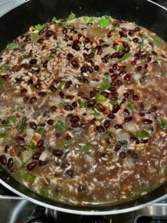 Cuban rice and beans simmering in a pan
