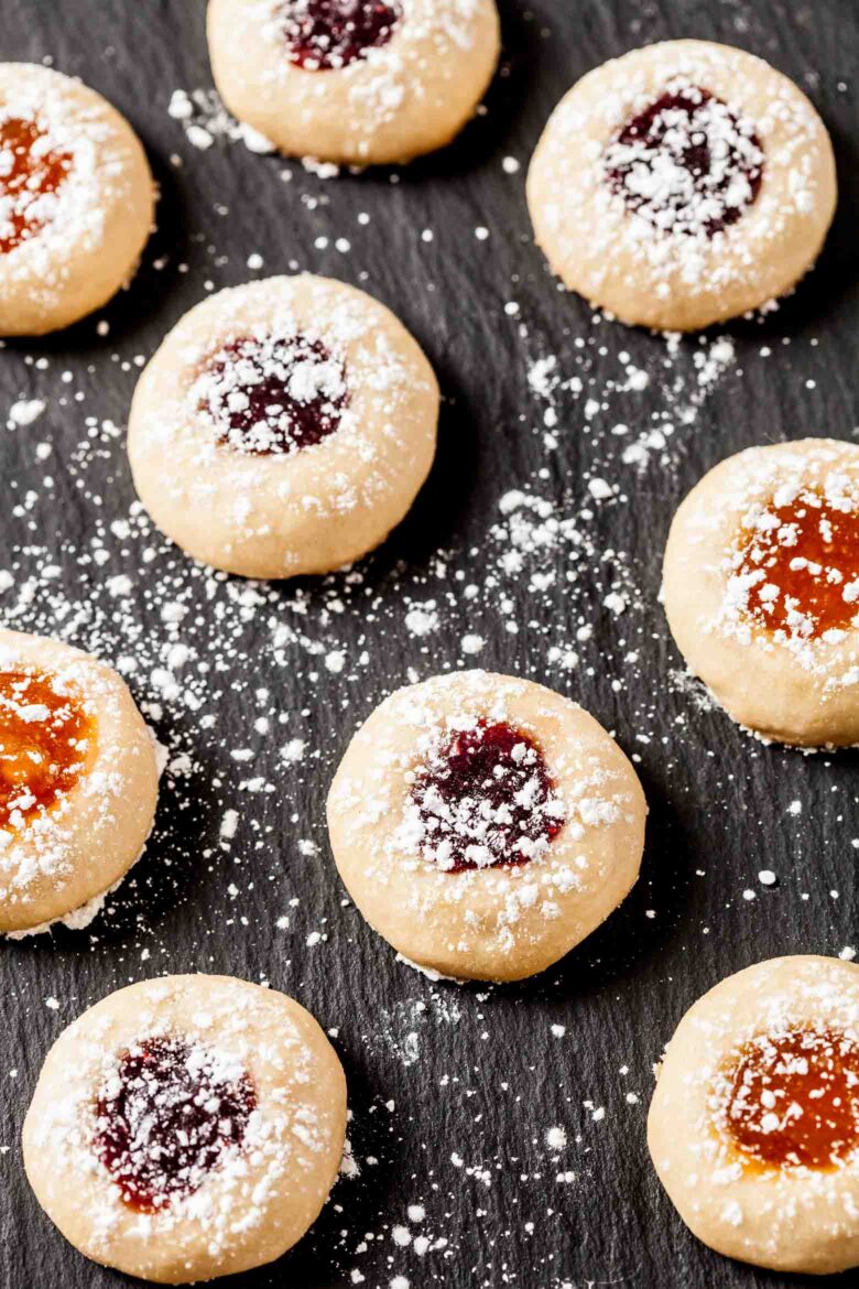 Jam Thumbprint Cookies on a black plate.