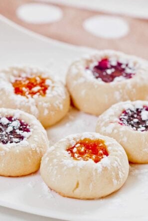 jam thumbprint cookies on a white plate.