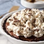 Chocolate pie with whipped cream in a pie plate
