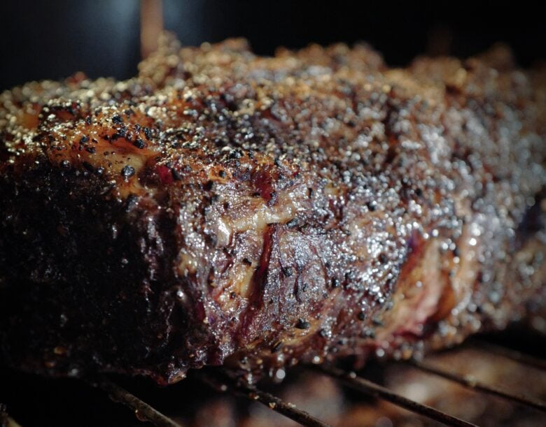 prime rib au jus cooking in the center rack of an oven 