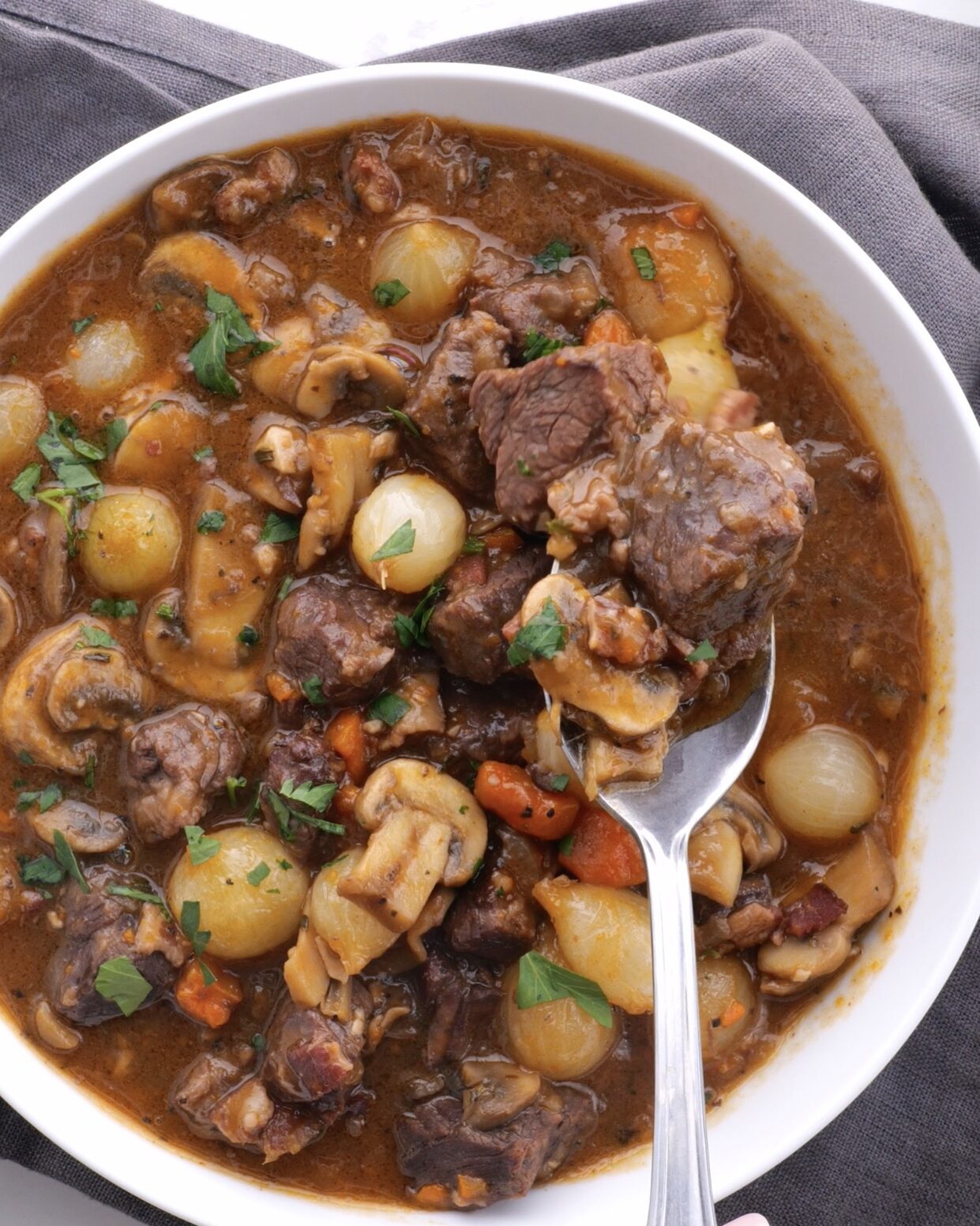 Boeuf bourguignon in a bowl with spoon