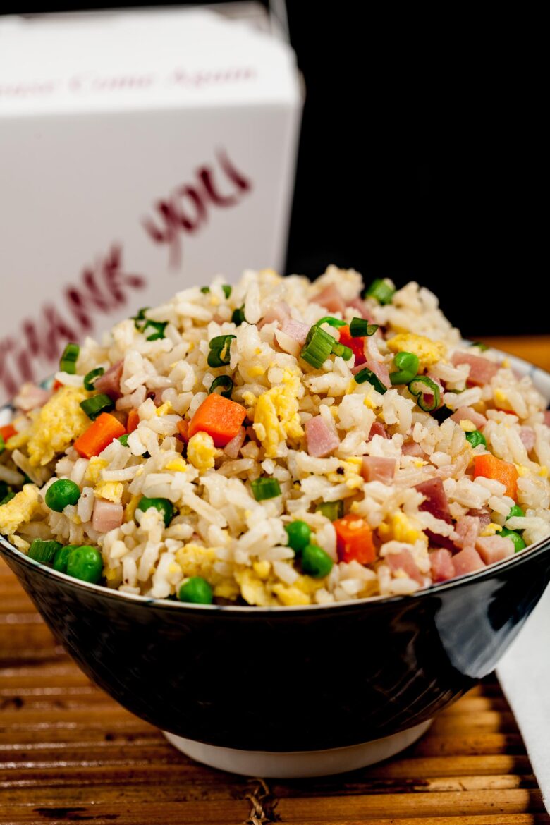 a bowl of ham fried rice with egg