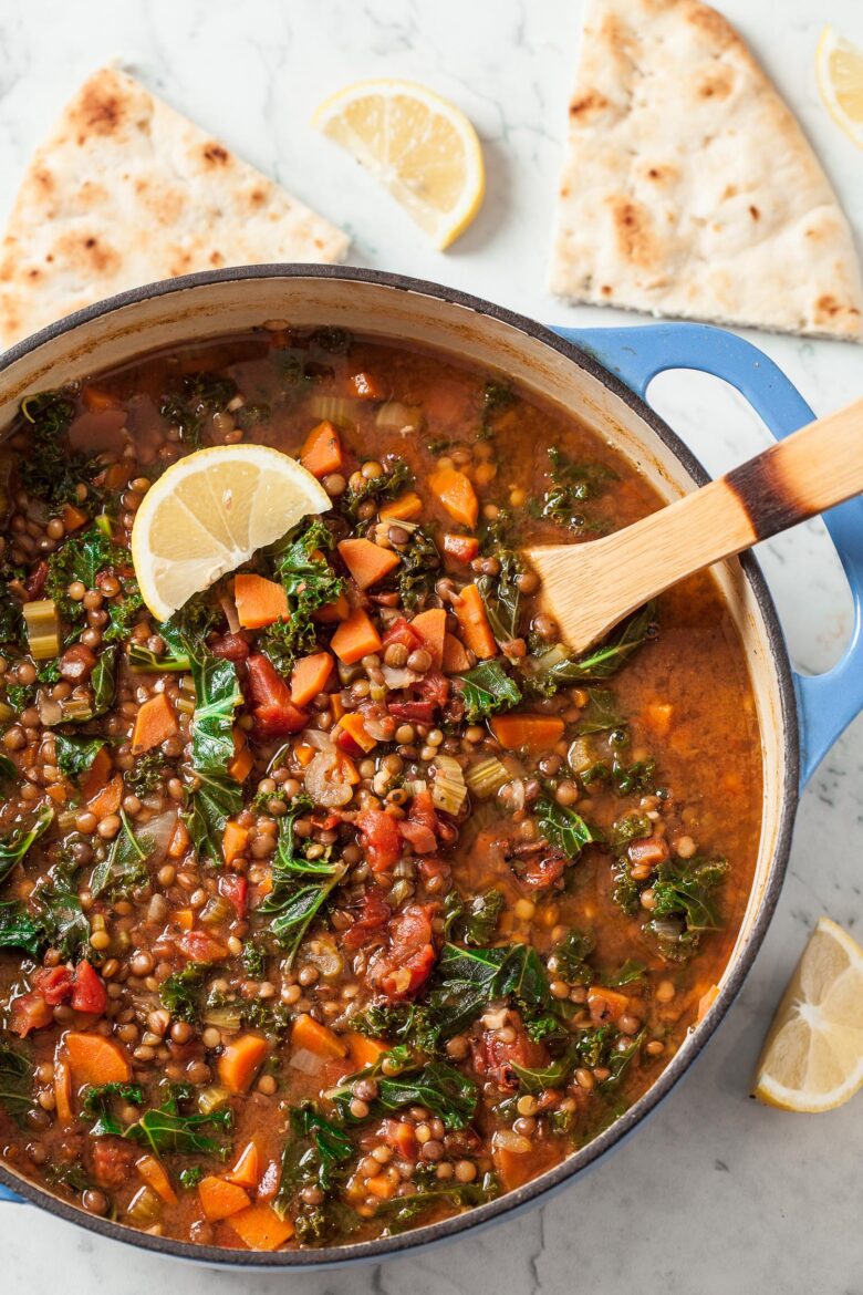 Lentil Soup in Pot with Pita Bread and Lemons