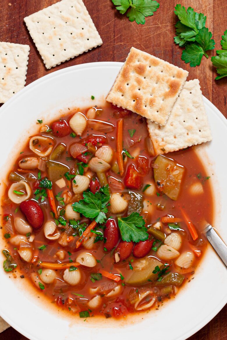 Minestrone Soup in a white bowl with crackers