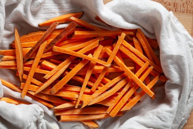 sweet potato fries being pat dry