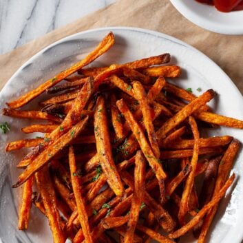 sweet potato fries in a bowl with ketchup on the side