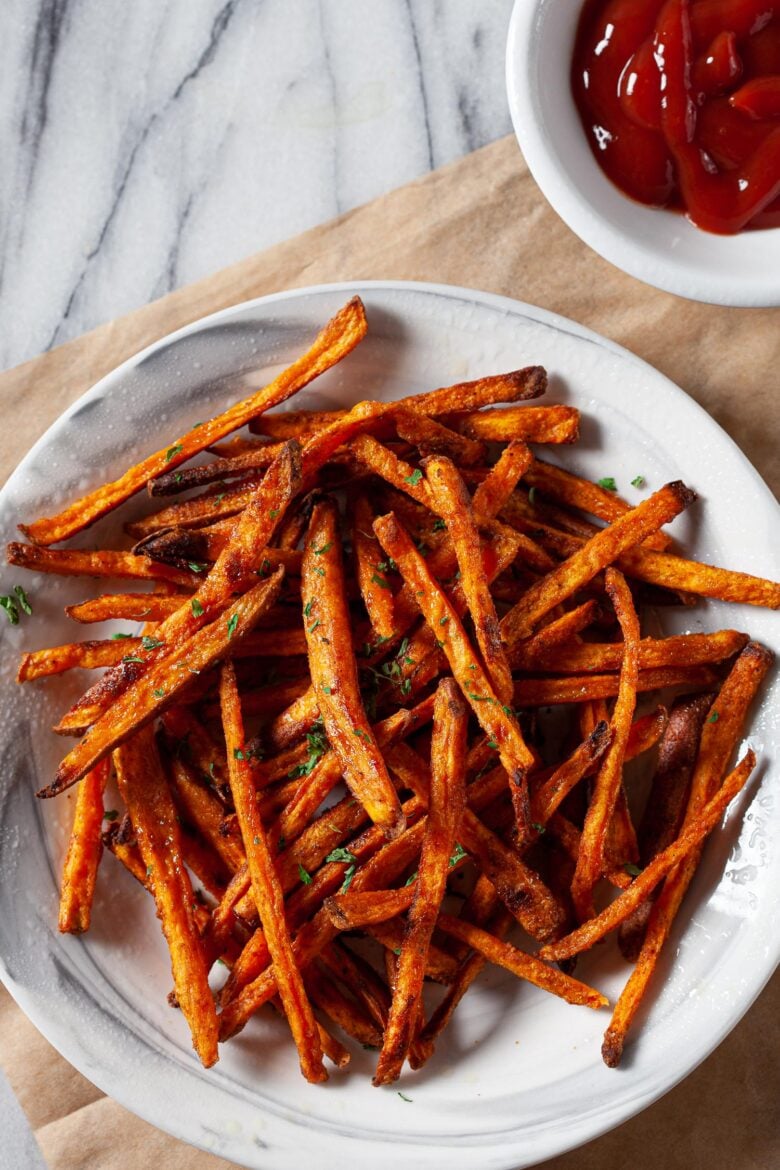 sweet potato fries in a bowl with ketchup on the side