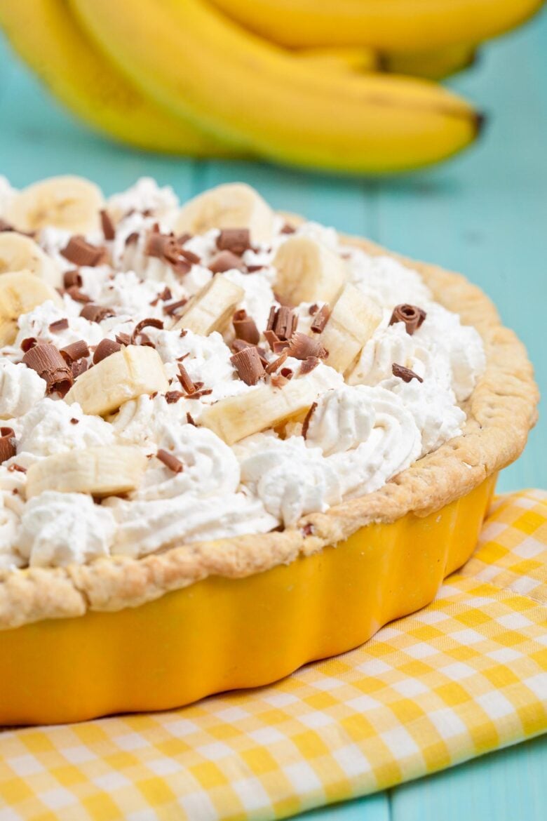 banana cream pie in a yellow pie pan 