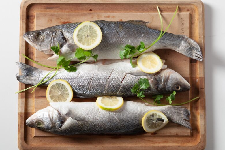 three uncooked branzino fish filets