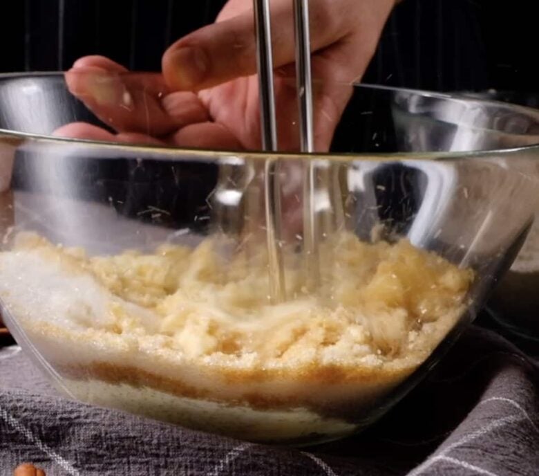 Butter and sugar ingredients mixed in a bowl.