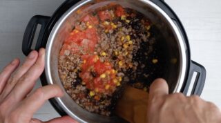 crockpot chili ingredients being combined