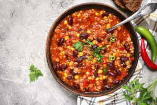 crockpot chili with a serving spoon sticking out