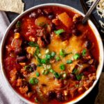 Instant Pot chili topped with cheese and green onions