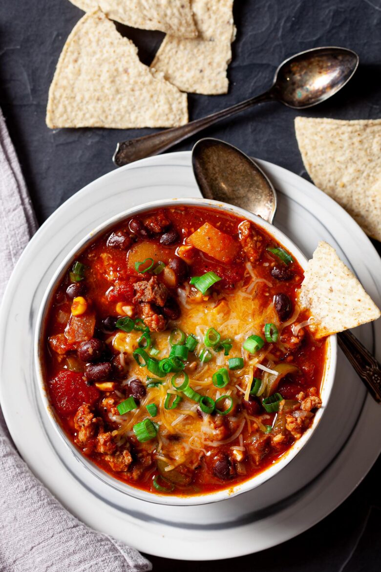 a bowl of instant pot chili with tortilla chips on the side