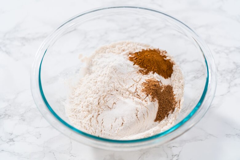 Dry Ingredients, including flour, cinnamon, nutmeg, baking soda, salt in a bowl. 