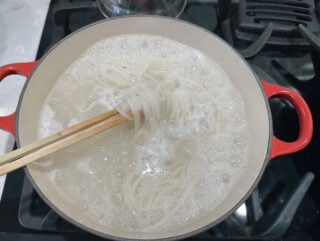 pad thai noodles soaking in a pot