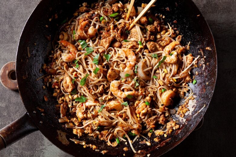 chicken and shrimp pad thai in a skillet