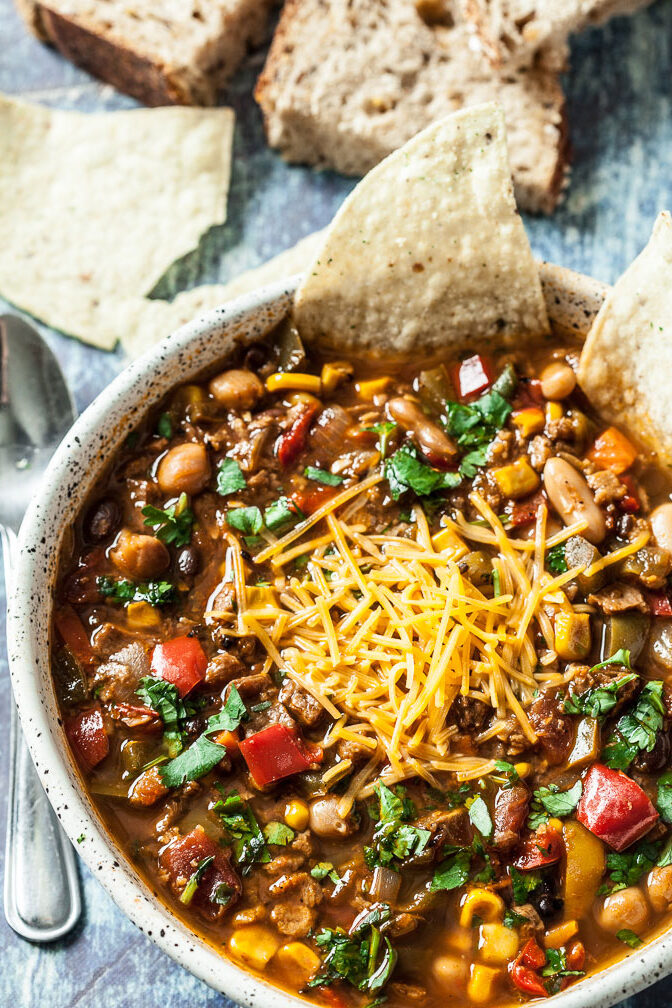 vegetarian chili, vegan chili in a bowl with cheese on top