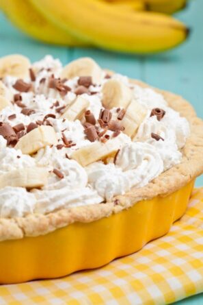 banana cream pie in a yellow pie pan