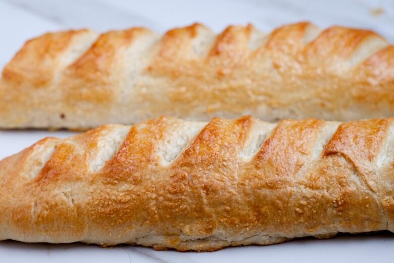 Two crusty French bread loaves side by side