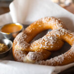 soft pretzels with coarse sea salt on top and mustard on the side