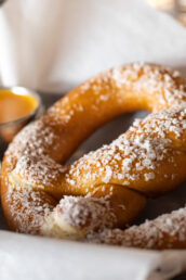 soft pretzels with coarse sea salt on top and mustard on the side