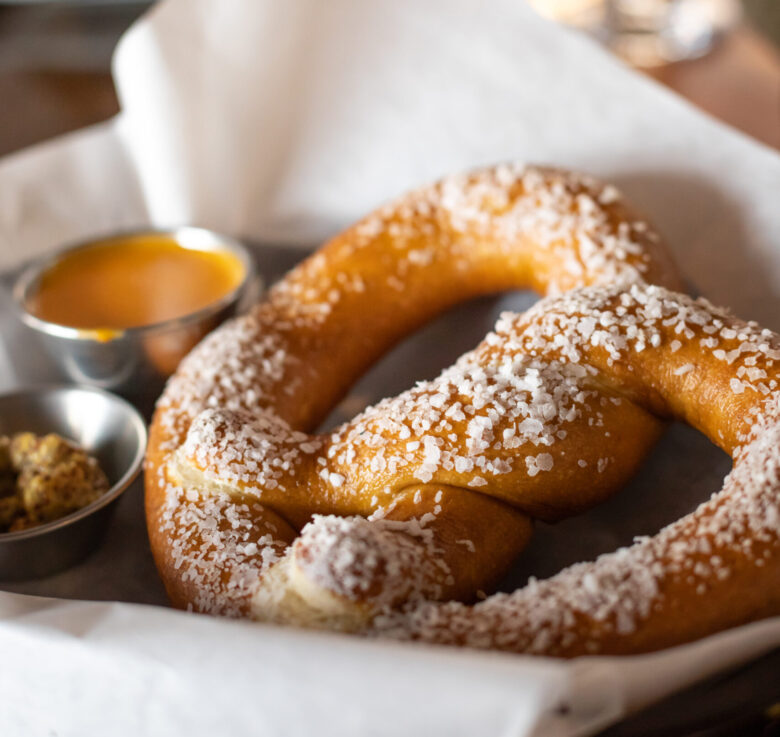 soft pretzels with coarse sea salt on top and mustard on the side