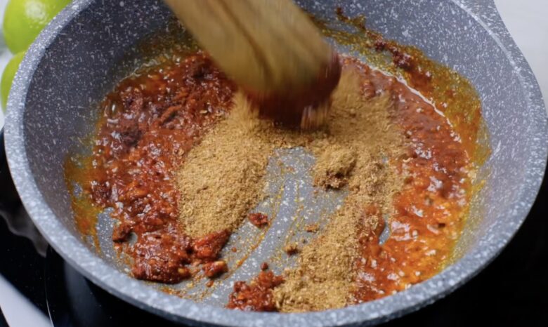 Garlic and spices cooking in a frying pan.