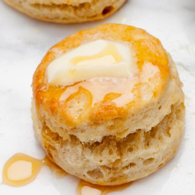Baked buttermilk biscuits with melted butter on top.