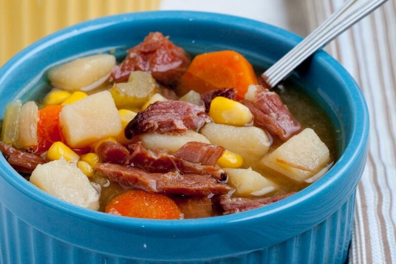 Ham Bone Soup with carrots and potatoes and beans in a bowl