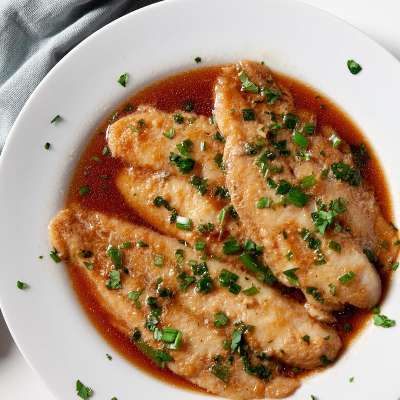 Swai fish fillets with sauce in baking dish for Chinese steamed fish