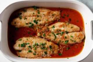 Swai fish fillets with sauce in baking dish for Chinese steamed fish