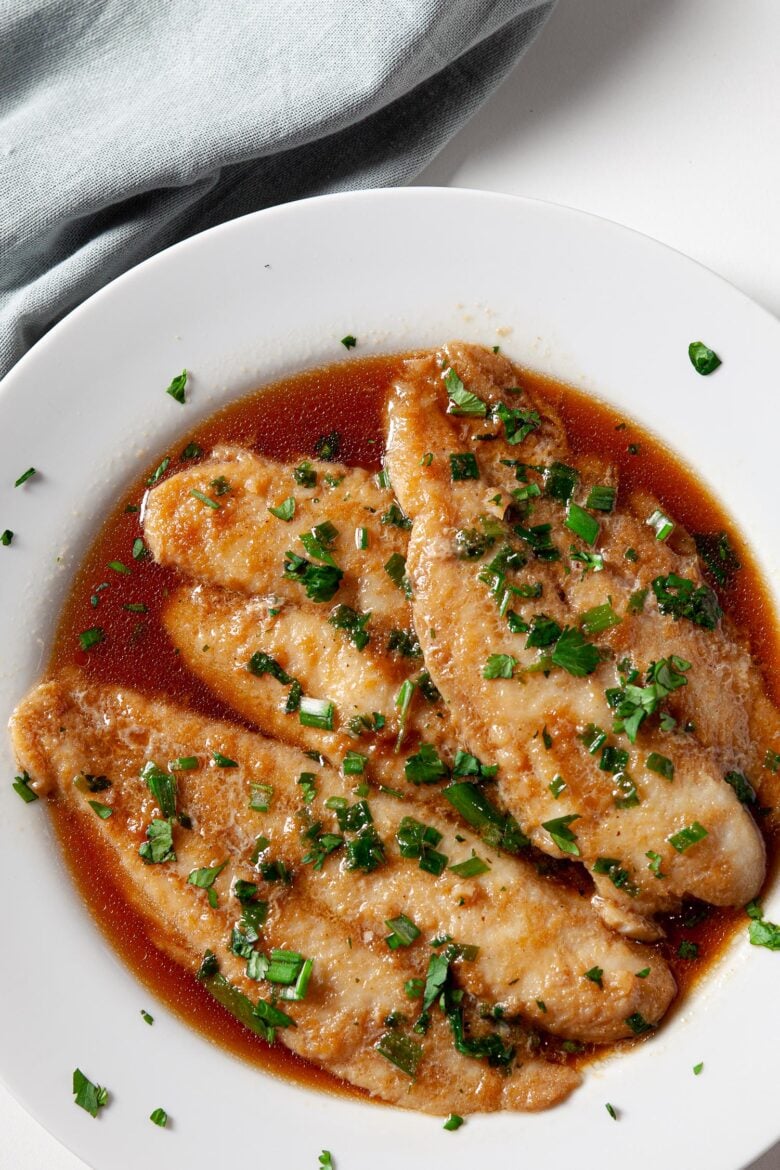 Swai fish fillets with sauce in baking dish for Chinese steamed fish