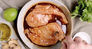 Grilled Chicken Breast being marinated in sauce
